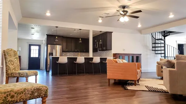 a living room with furniture and wooden floor