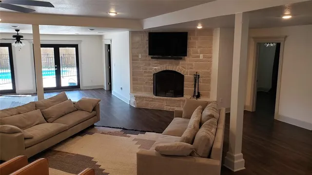 a kitchen with granite countertop a table chairs microwave and refrigerator