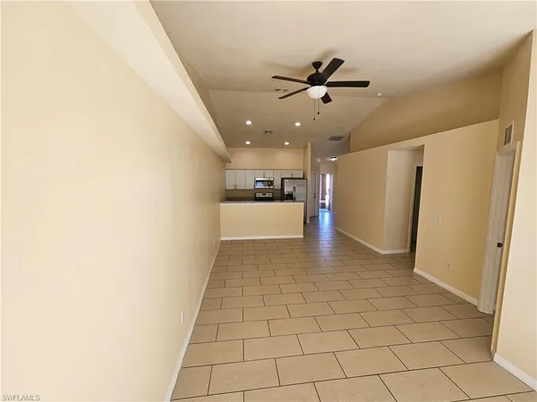 a view of a kitchen with a sink and a refrigerator