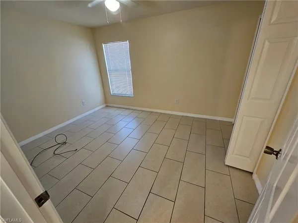 a kitchen with granite countertop a stove a sink and a refrigerator