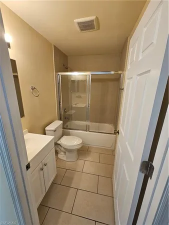 a bathroom with a sink and mirror with bathtub