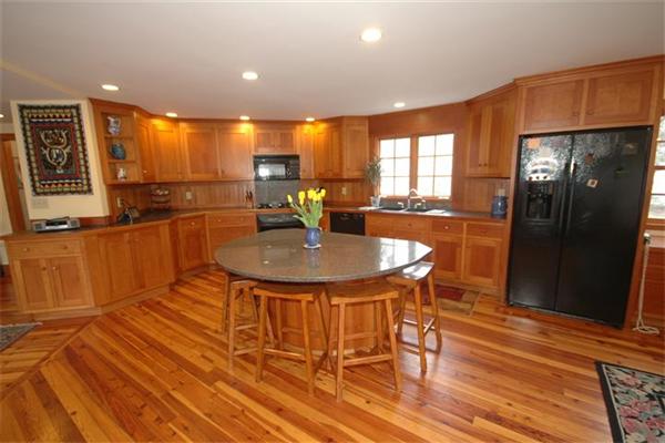 76 Holt Road Andover, MA 01810 - Photo 3 of 30 a kitchen with stainless steel appliances wooden floor dining table and chairs