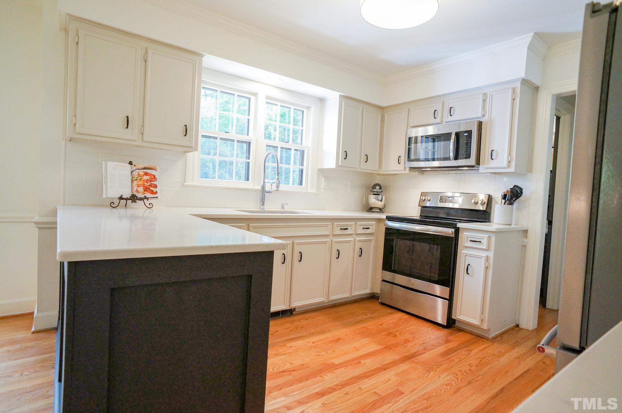 408 Emerywood Drive Raleigh, NC 27615 - Photo 12 of 44 a kitchen with a sink cabinets and window