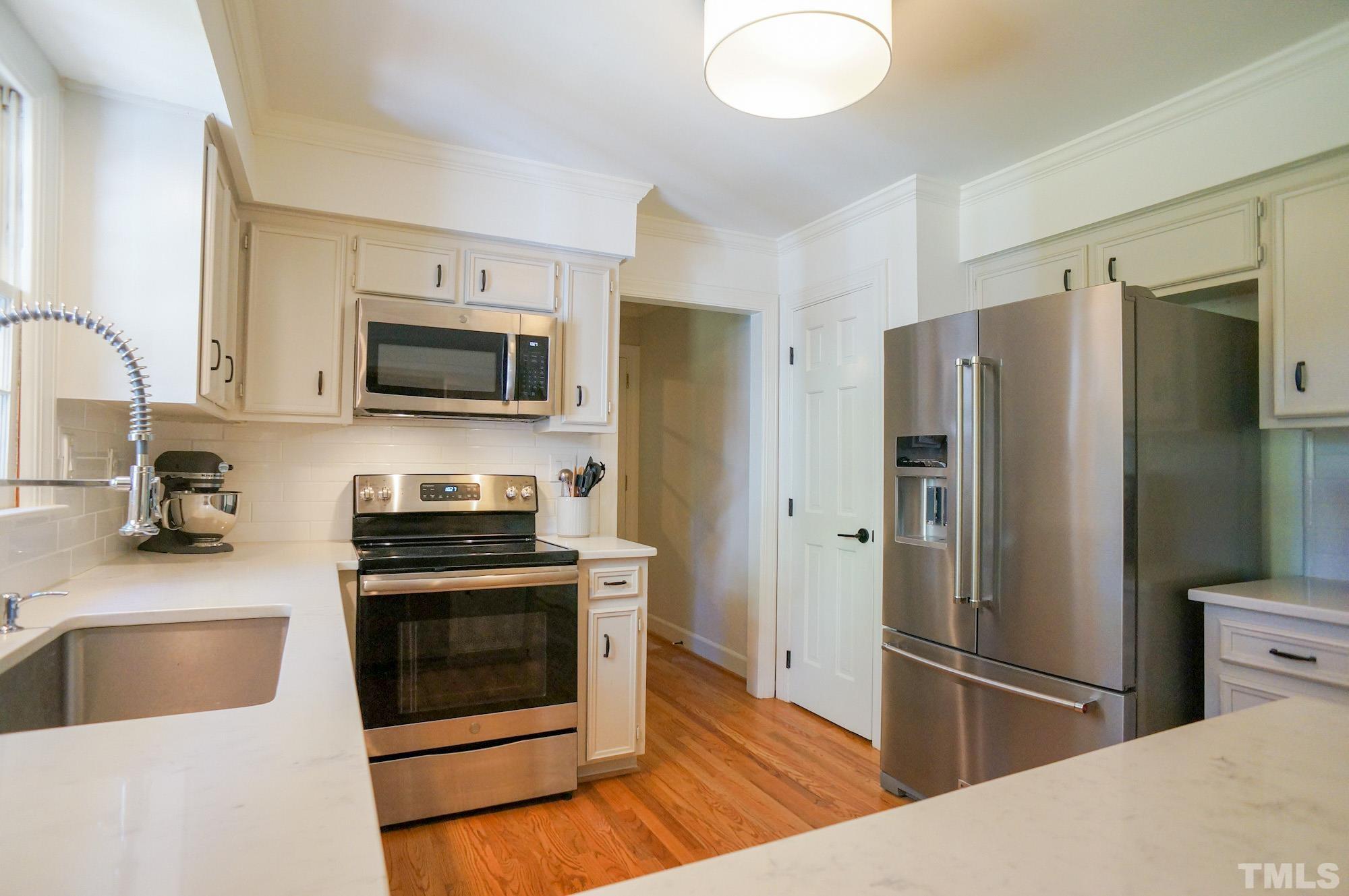 408 Emerywood Drive Raleigh, NC 27615 - Photo 13 of 44 a kitchen with stainless steel appliances granite countertop a refrigerator stove and sink