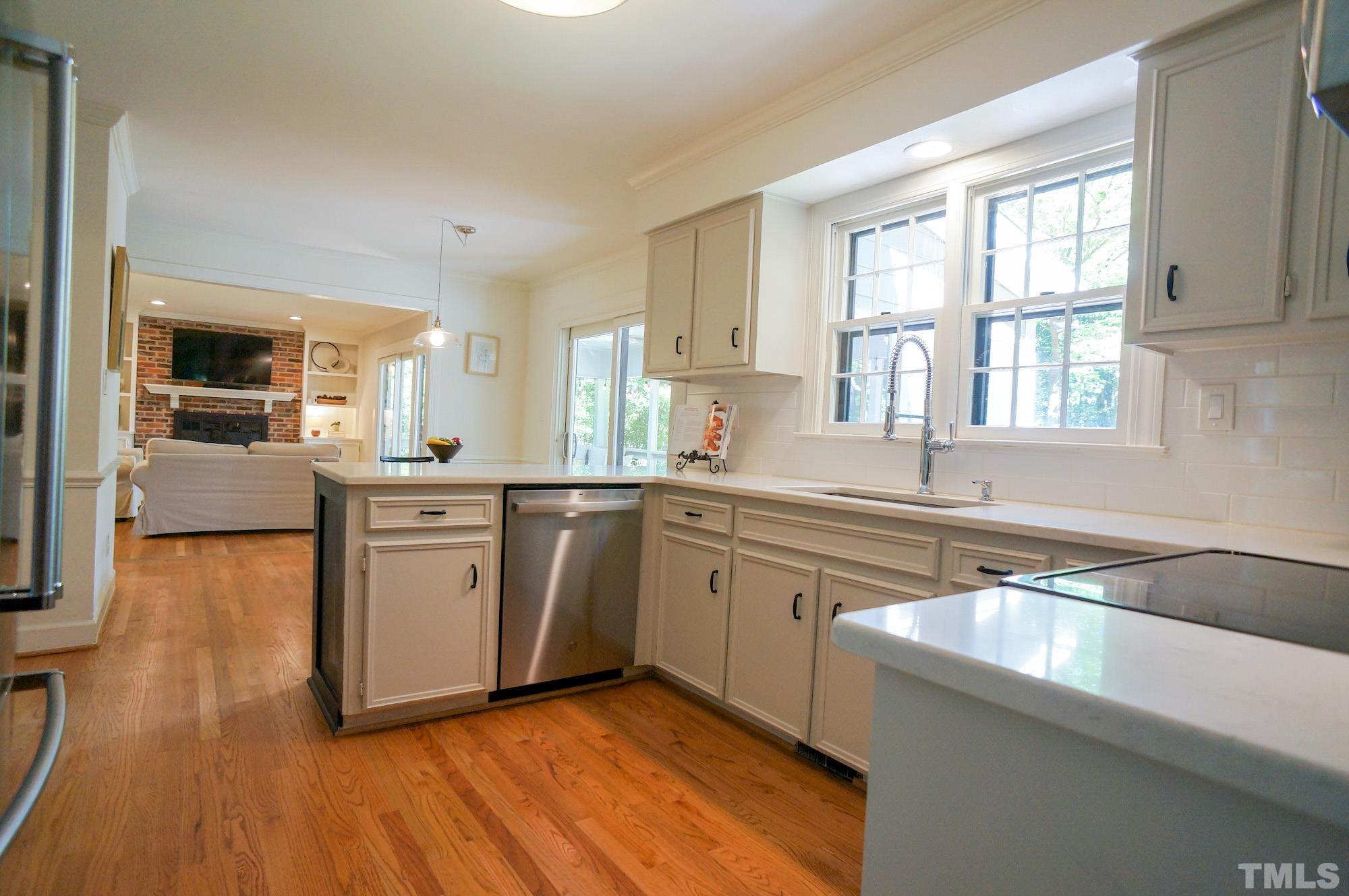 408 Emerywood Drive Raleigh, NC 27615 - Photo 16 of 44 a kitchen with stainless steel appliances granite countertop a sink cabinets and wooden floor