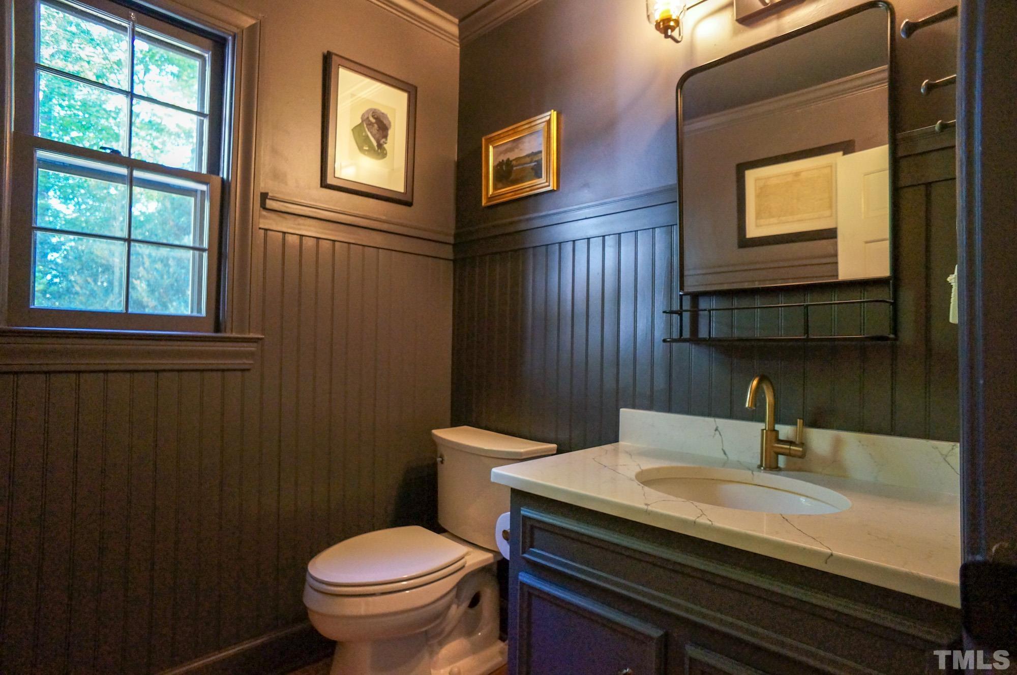 408 Emerywood Drive Raleigh, NC 27615 - Photo 17 of 44 a bathroom with a sink a toilet and a mirror