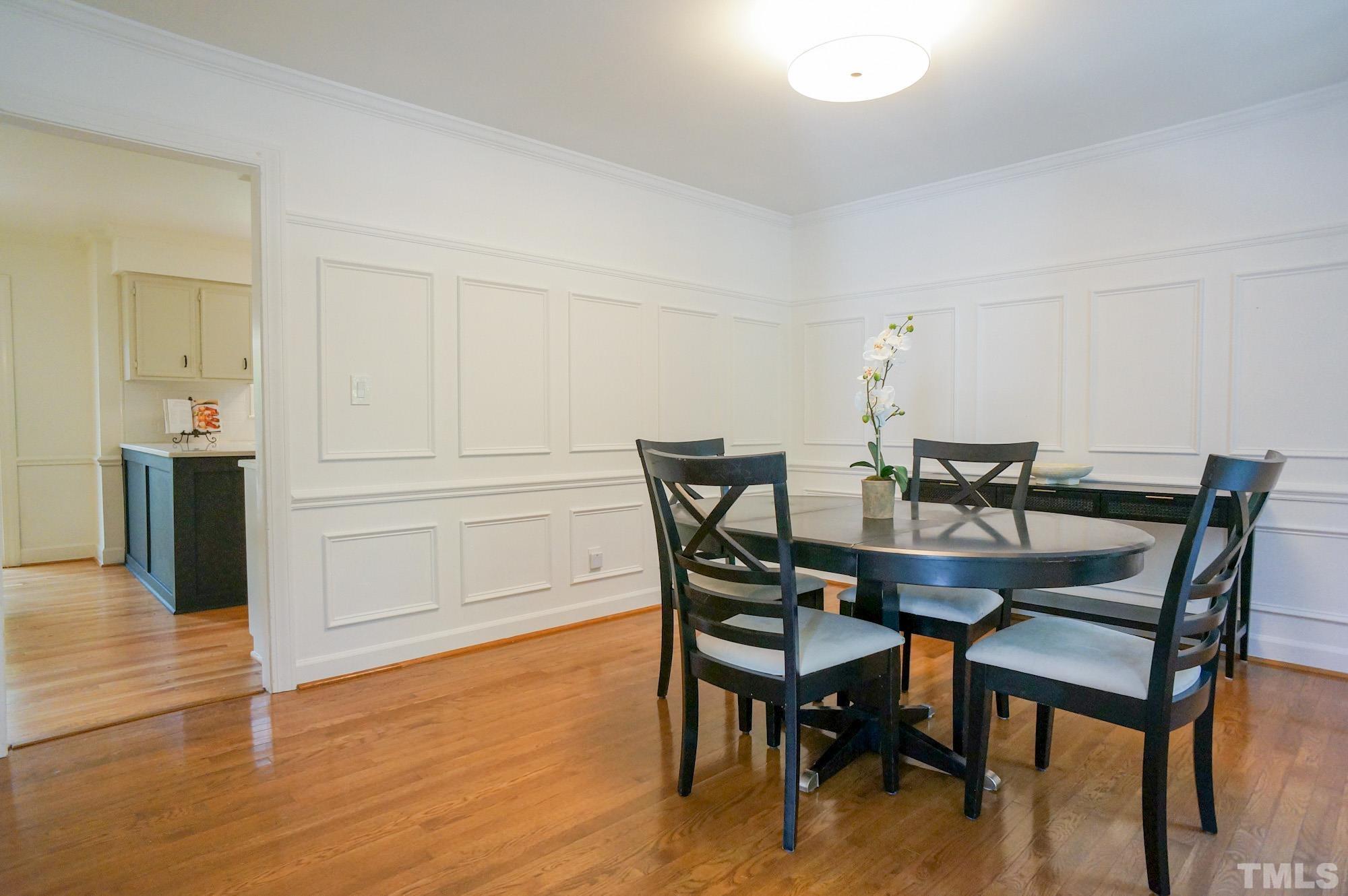408 Emerywood Drive Raleigh, NC 27615 - Photo 18 of 44 a view of a dining room with furniture and wooden floor