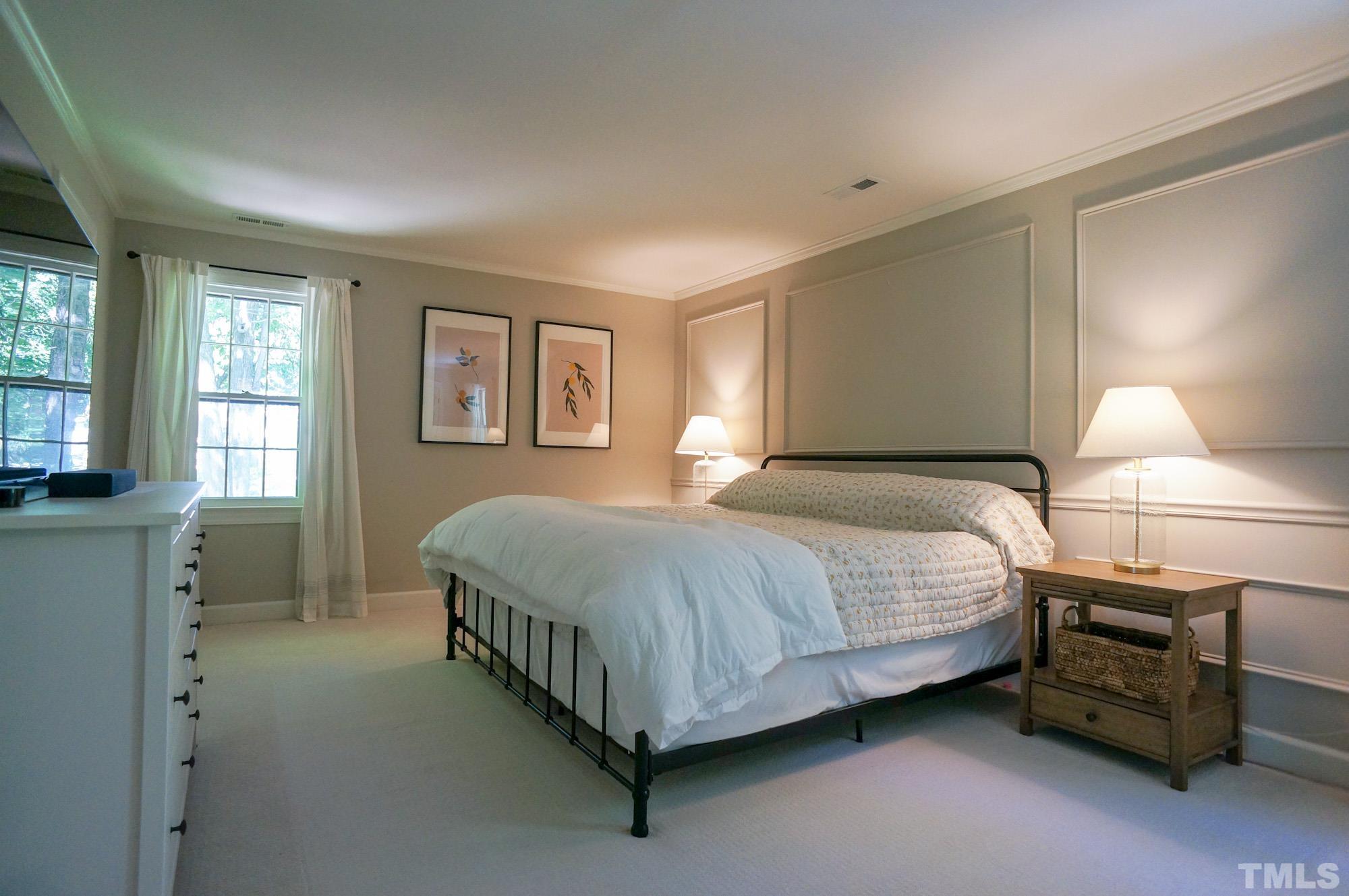 408 Emerywood Drive Raleigh, NC 27615 - Photo 20 of 44 a spacious bedroom with a bed and a cabinets