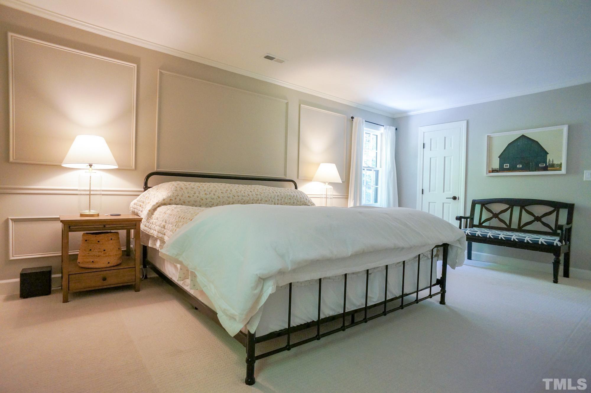 408 Emerywood Drive Raleigh, NC 27615 - Photo 21 of 44 a bed sitting in a bedroom next to a lamp