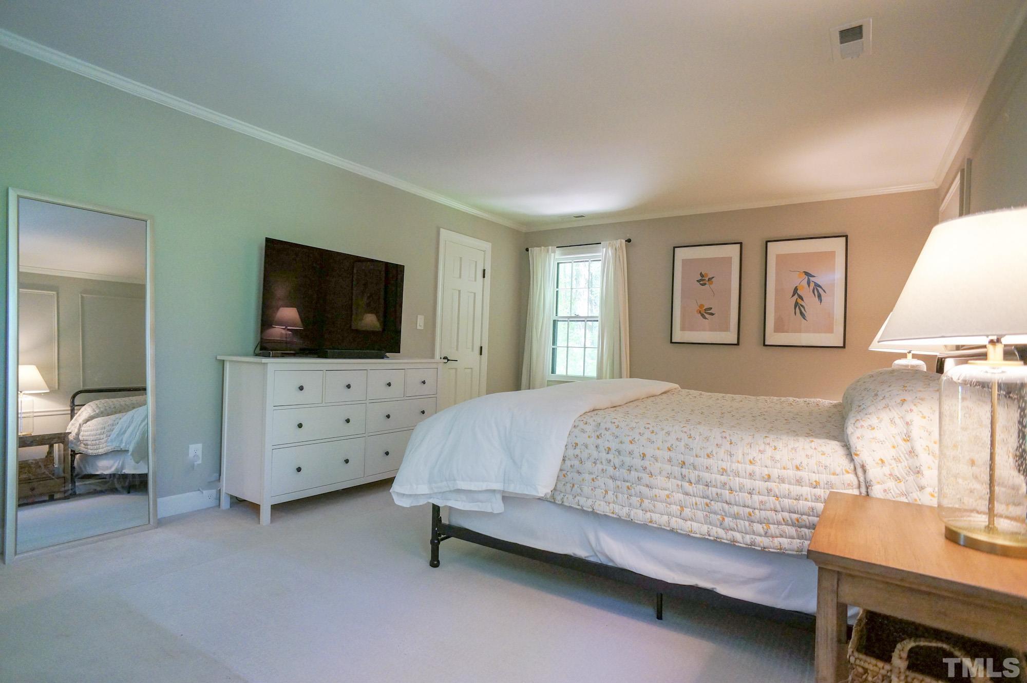 408 Emerywood Drive Raleigh, NC 27615 - Photo 22 of 44 a bedroom with a bed and a flat screen tv