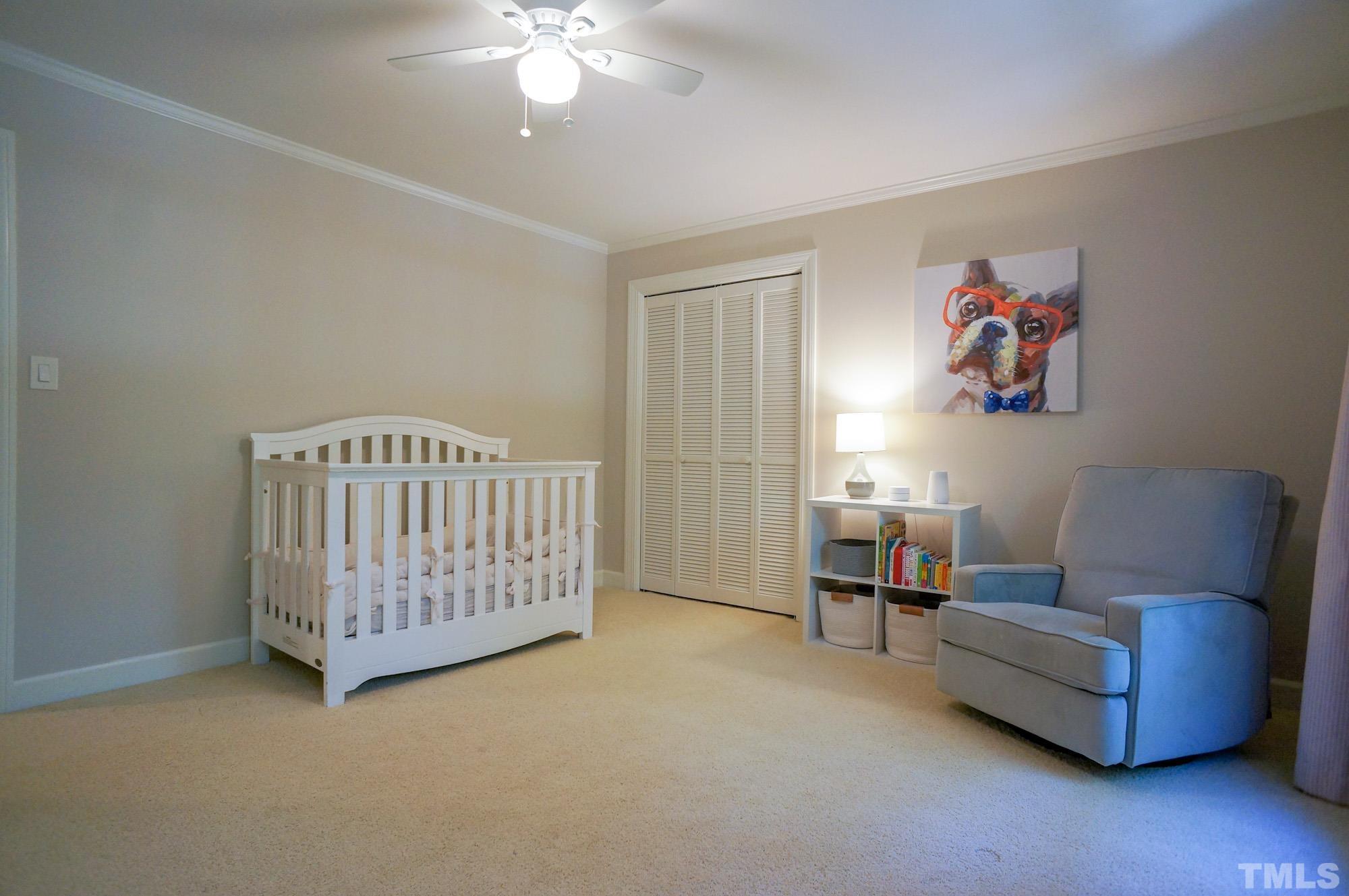 408 Emerywood Drive Raleigh, NC 27615 - Photo 27 of 44 a bedroom with furniture and a chandelier