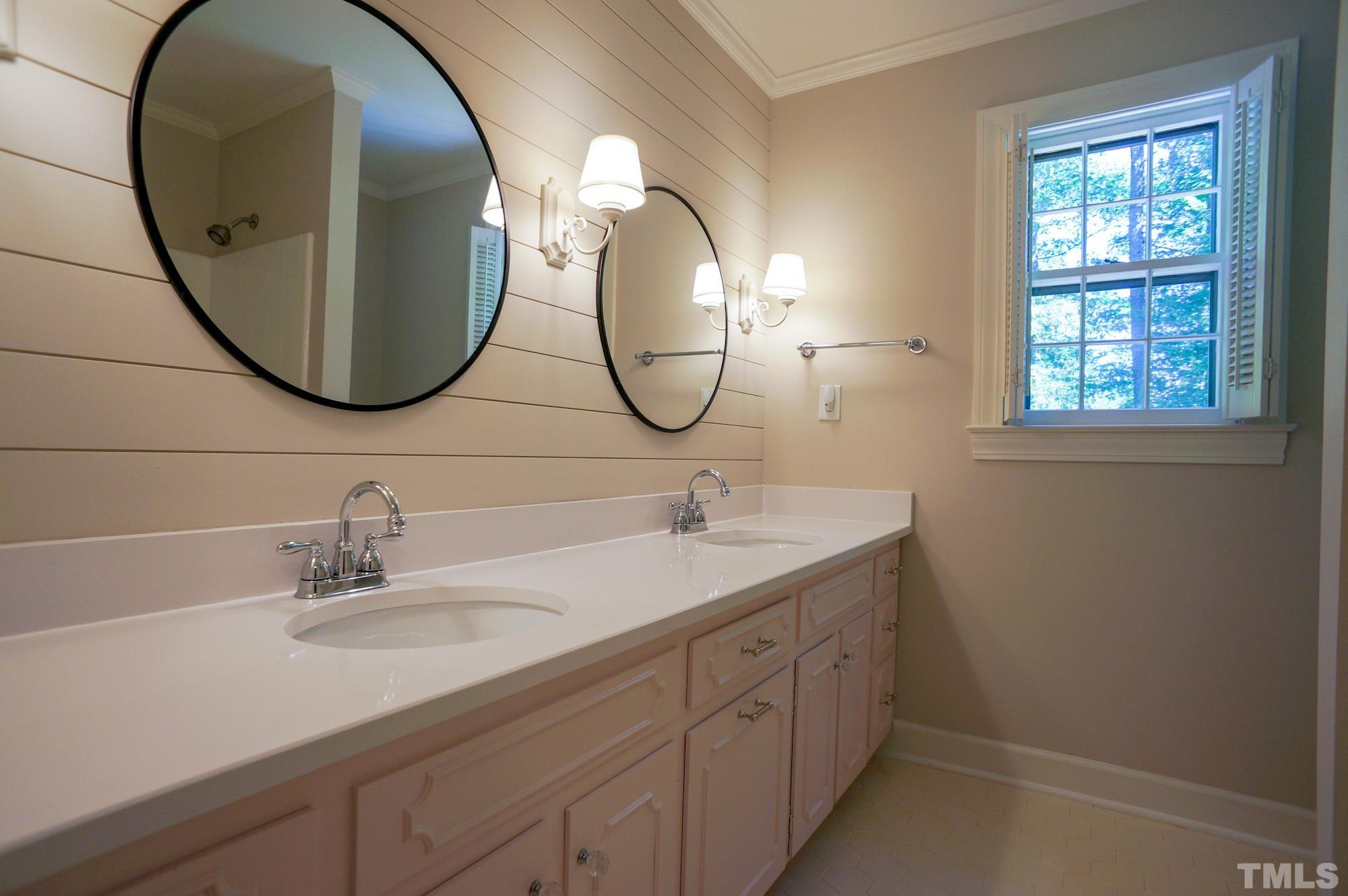 408 Emerywood Drive Raleigh, NC 27615 - Photo 28 of 44 a bathroom with a sink and a mirror
