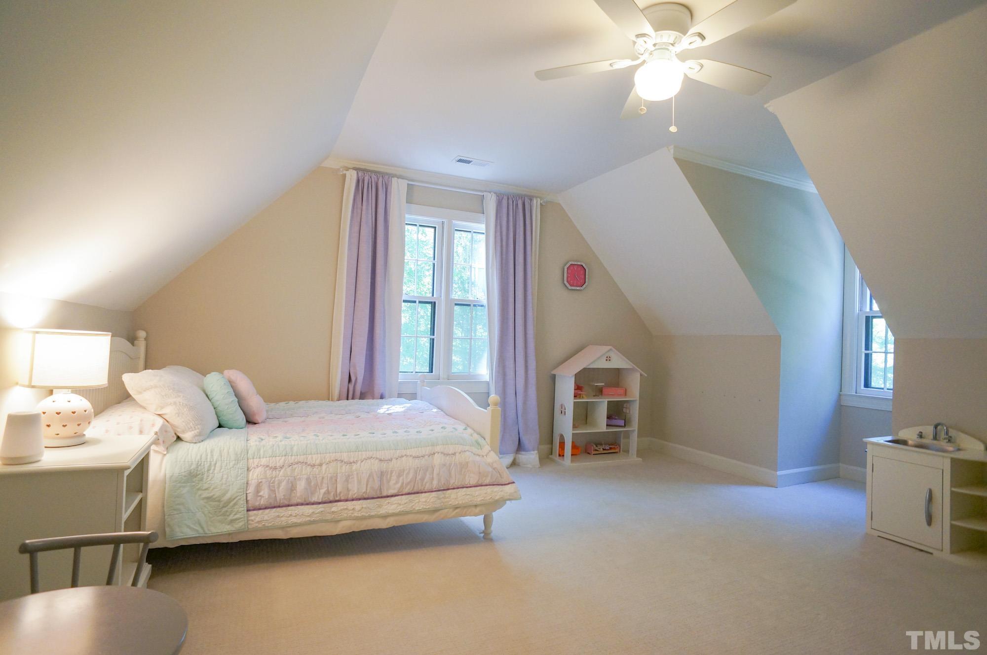 408 Emerywood Drive Raleigh, NC 27615 - Photo 29 of 44 a bedroom with a bed and a chandelier