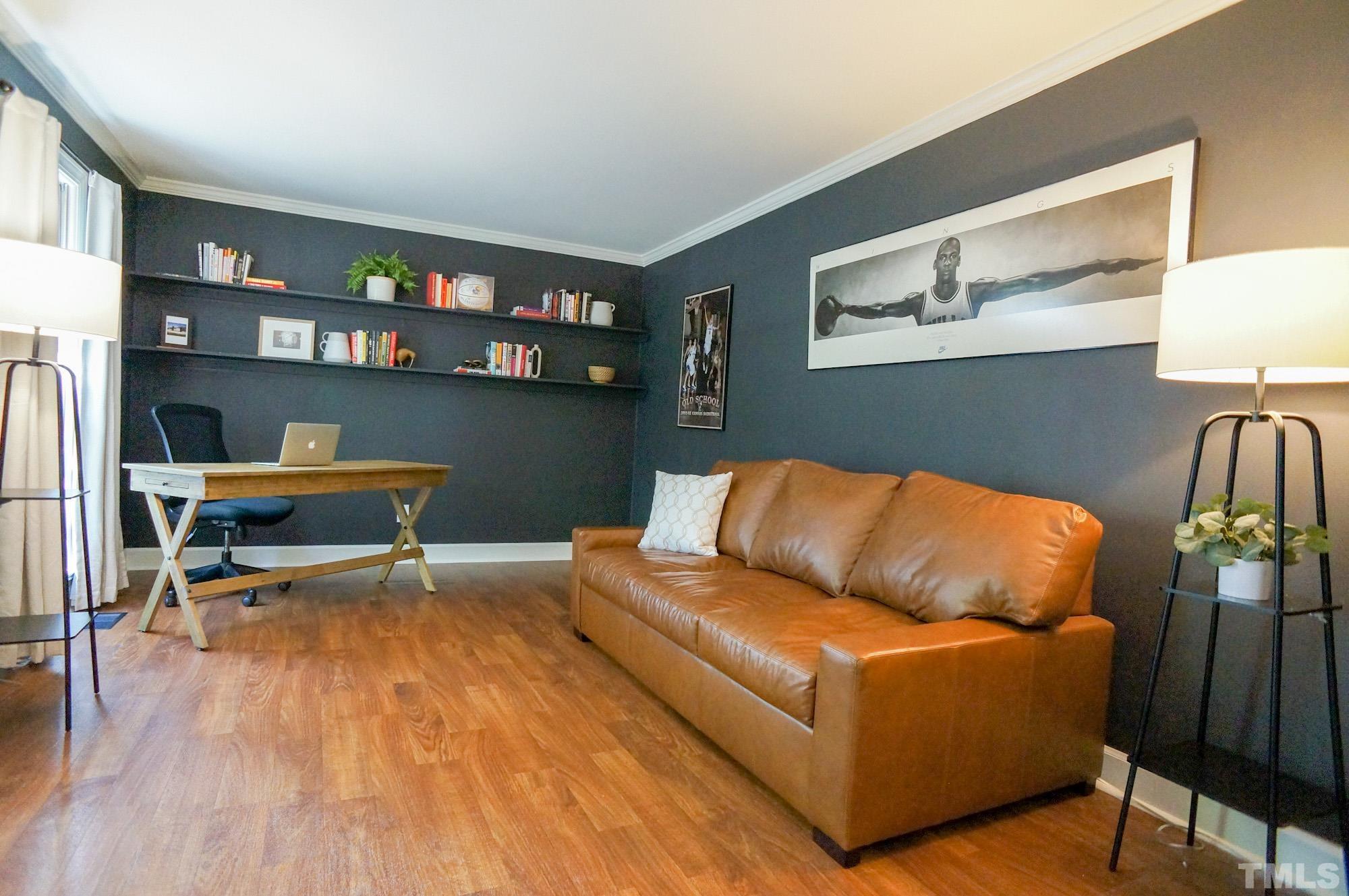 408 Emerywood Drive Raleigh, NC 27615 - Photo 3 of 44 a living room with furniture a lamp and a flat screen tv