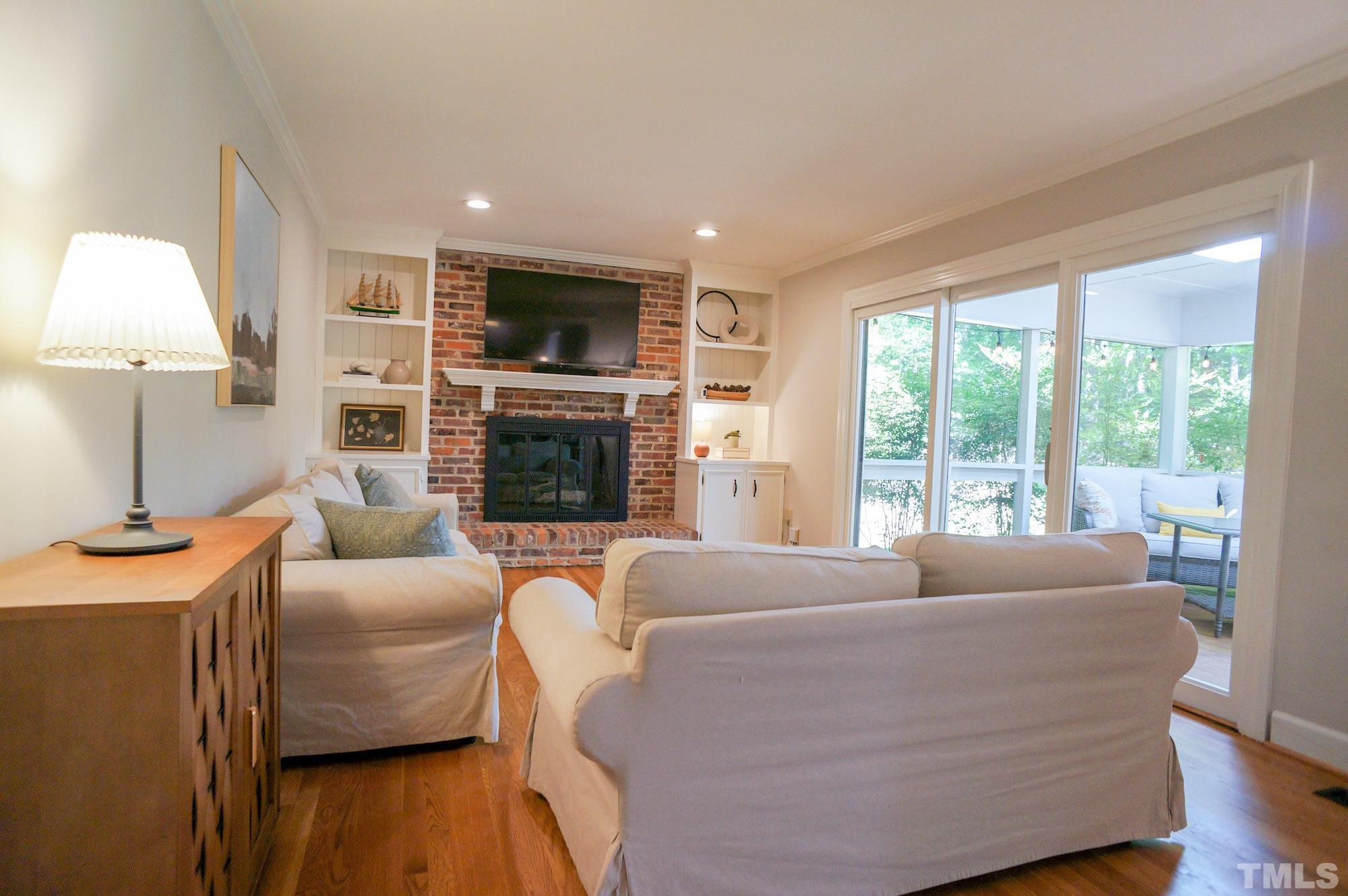 408 Emerywood Drive Raleigh, NC 27615 - Photo 5 of 44 a living room with fireplace furniture and a flat screen tv