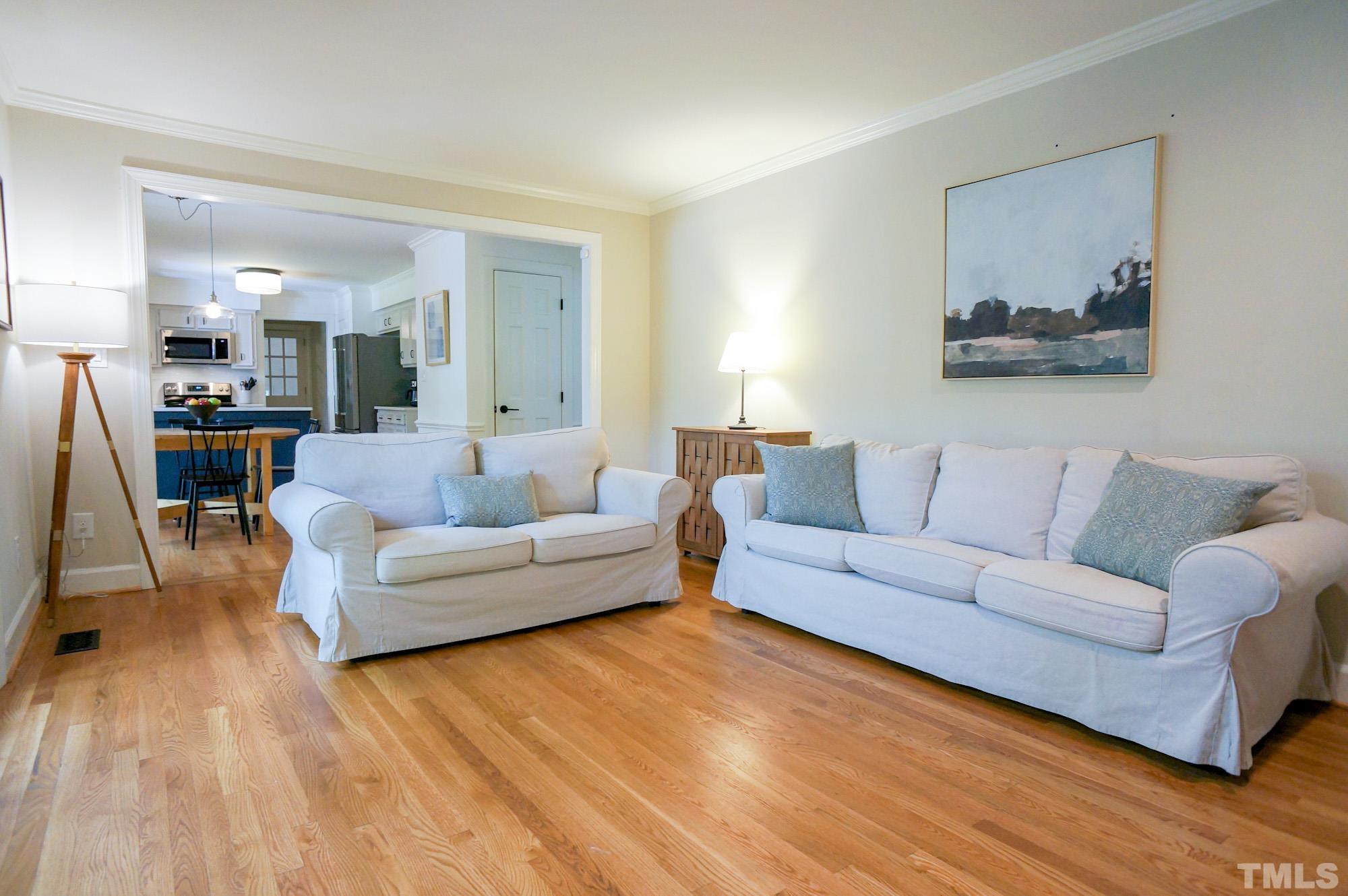 408 Emerywood Drive Raleigh, NC 27615 - Photo 7 of 44 a living room with furniture and a wooden floor