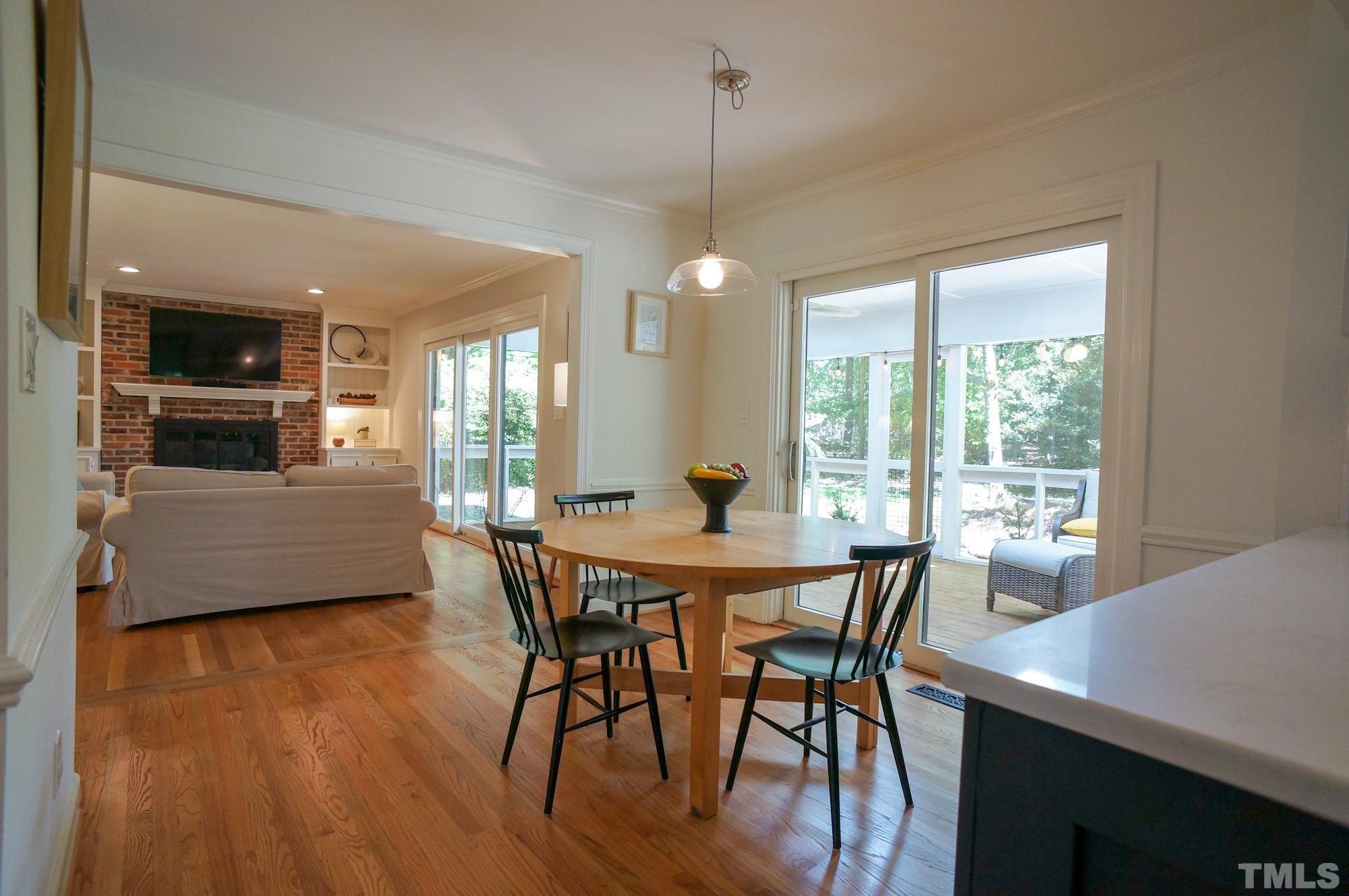 408 Emerywood Drive Raleigh, NC 27615 - Photo 9 of 44 a view of a dining room with furniture window and wooden floor