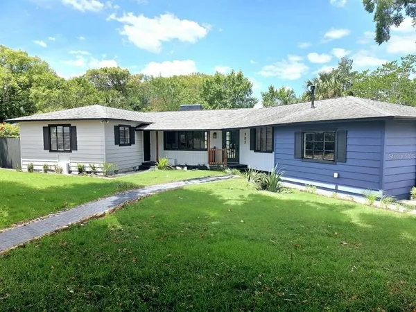 a front view of house with yard and green space