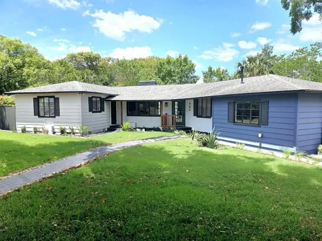 a front view of house with yard and green space
