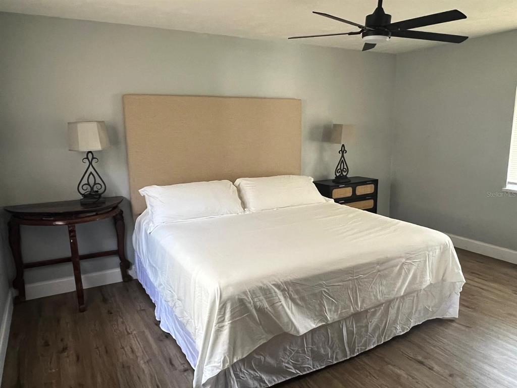 905 West 11th Avenue Mount Dora, FL 32757 - Photo 15 of 25 a bedroom with a bed and a night stand