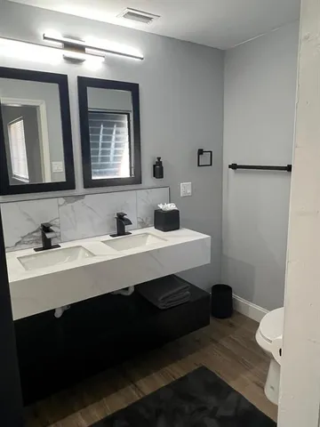 a bathroom with a sink double vanity and a mirror