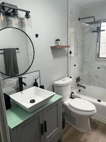 a bathroom with a toilet sink and mirror