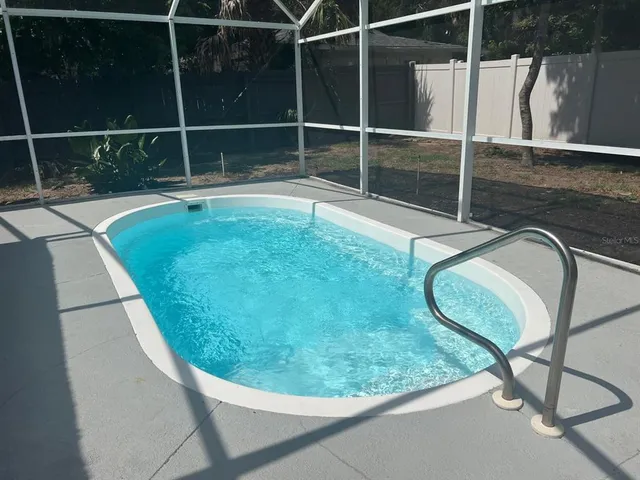 a view of a swimming pool with a chair