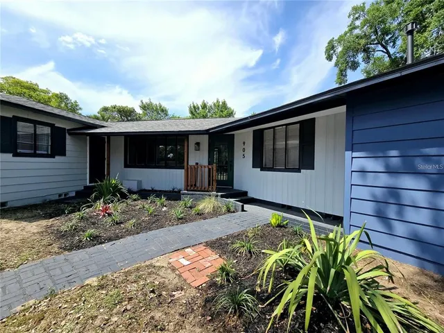 a front view of a house with garden