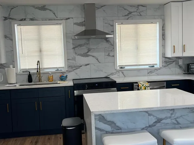 a kitchen with a sink a stove a refrigerator and cabinets