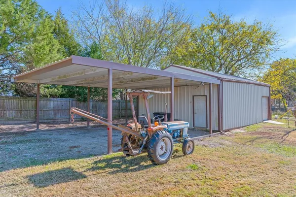 a view of a house with wooden fence
