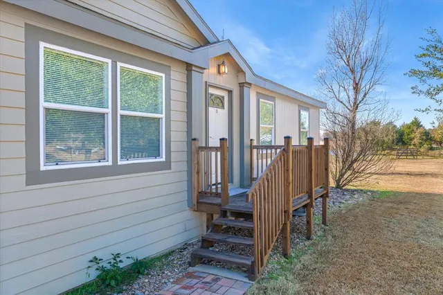 a large kitchen with kitchen island a stove a sink cabinets and wooden floor
