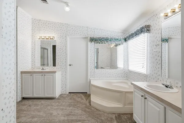a bathroom with a shower sink and mirror
