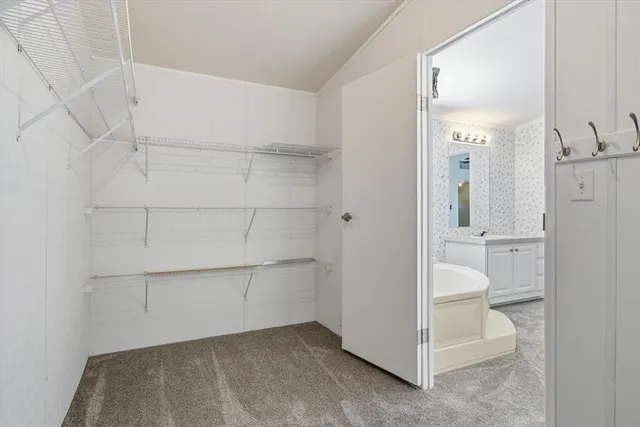 a kitchen with kitchen island granite countertop a sink and a refrigerator