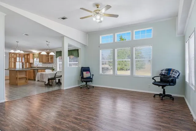 a large kitchen with a table chairs and a chandelier