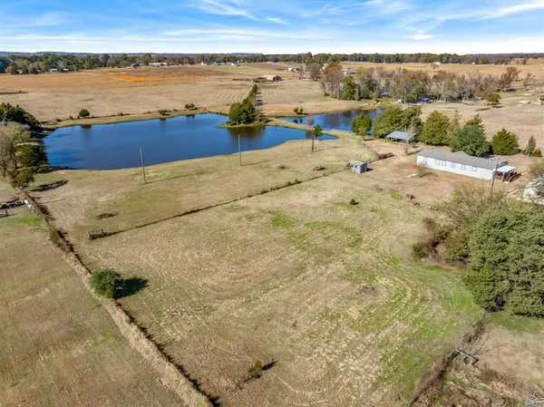 a view of a yard with wooden fence