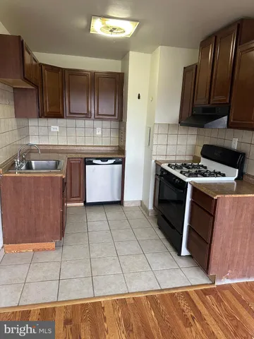 a kitchen with a sink a stove and a microwave