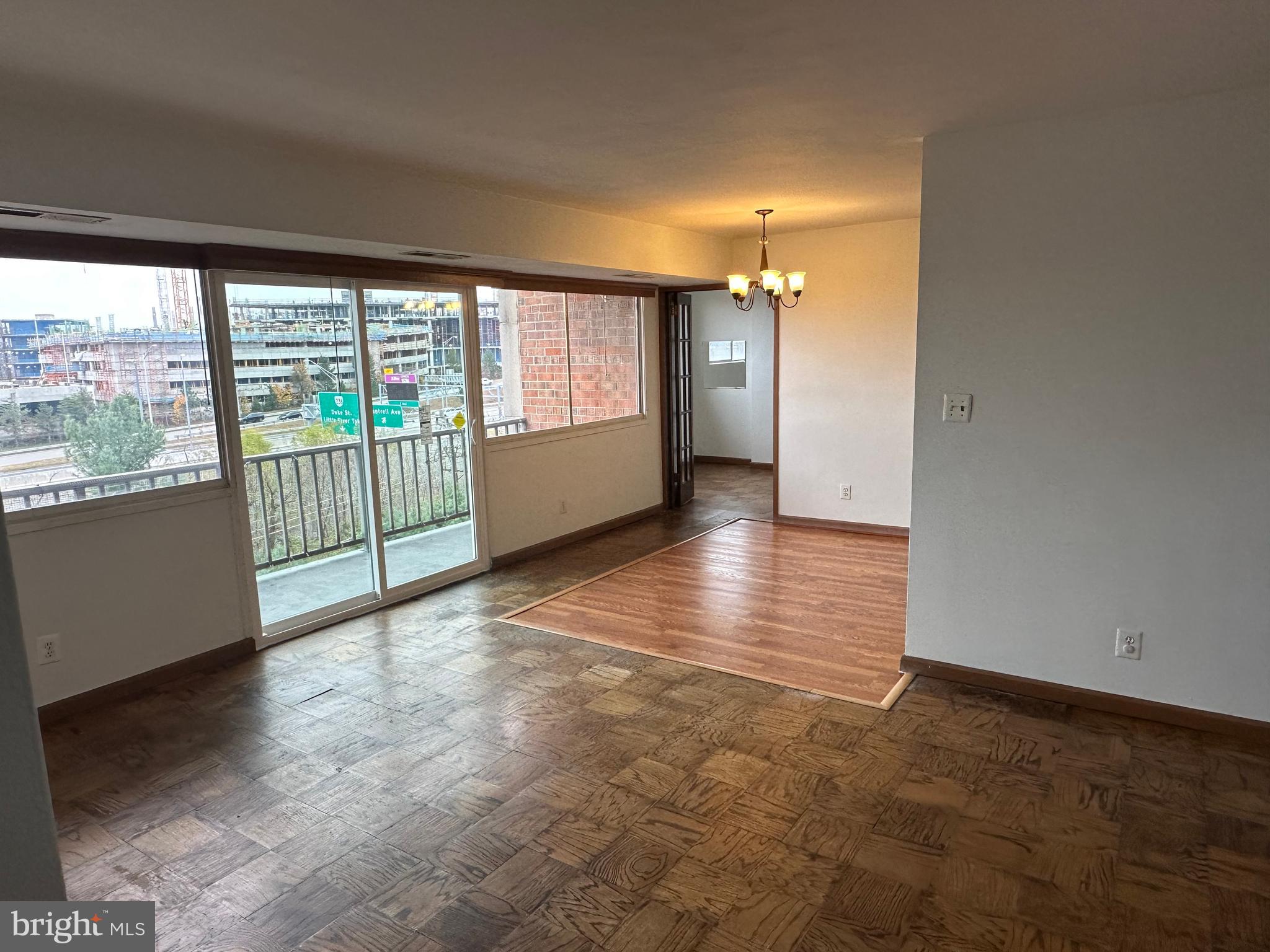 5801 Quantrell Avenue, Unit 407 Alexandria, VA 22312 - Photo 10 of 14 wooden floor in an empty room with a window