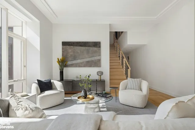 a living room with furniture and large windows