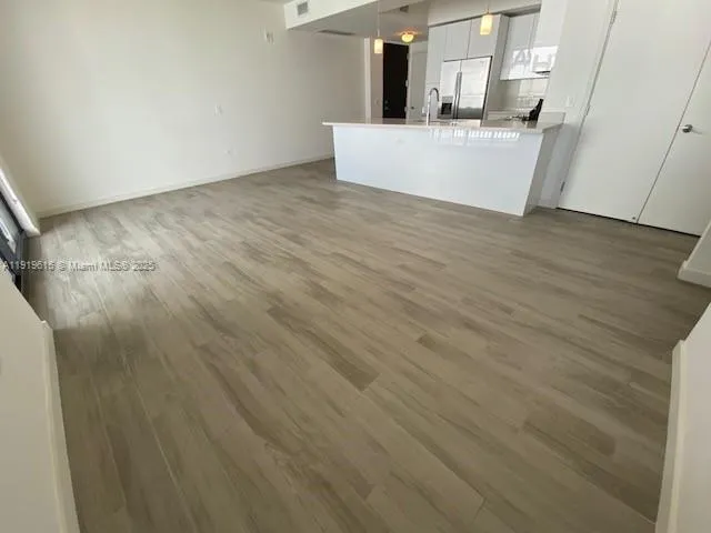 a view of a kitchen with wooden floor
