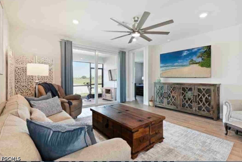 17799 Oleander Avenue Punta Gorda, FL 33982 - Photo 3 of 19 a living room with furniture a rug and a chandelier