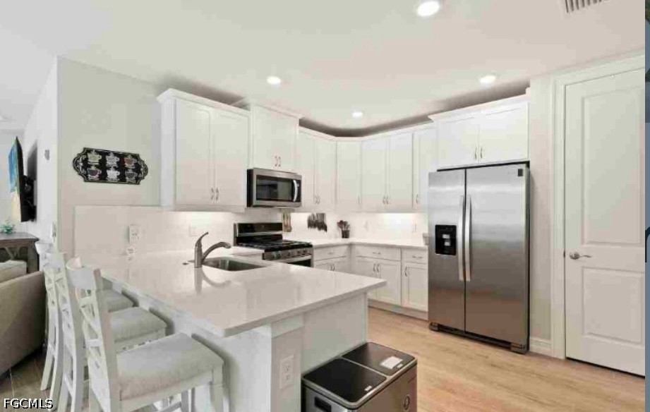 17799 Oleander Avenue Punta Gorda, FL 33982 - Photo 6 of 19 a kitchen with stainless steel appliances a refrigerator stove microwave and sink