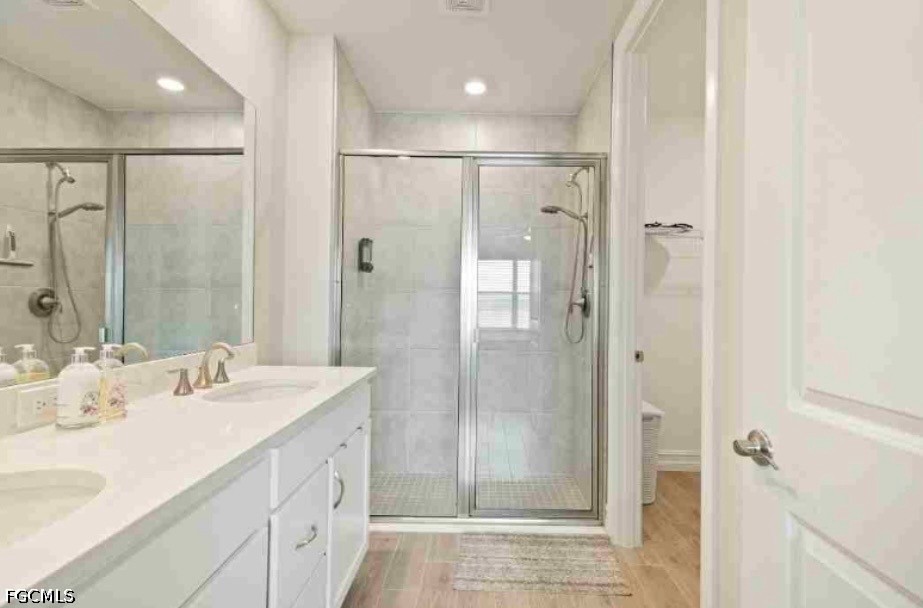 17799 Oleander Avenue Punta Gorda, FL 33982 - Photo 10 of 19 a bathroom with a shower sink and mirror