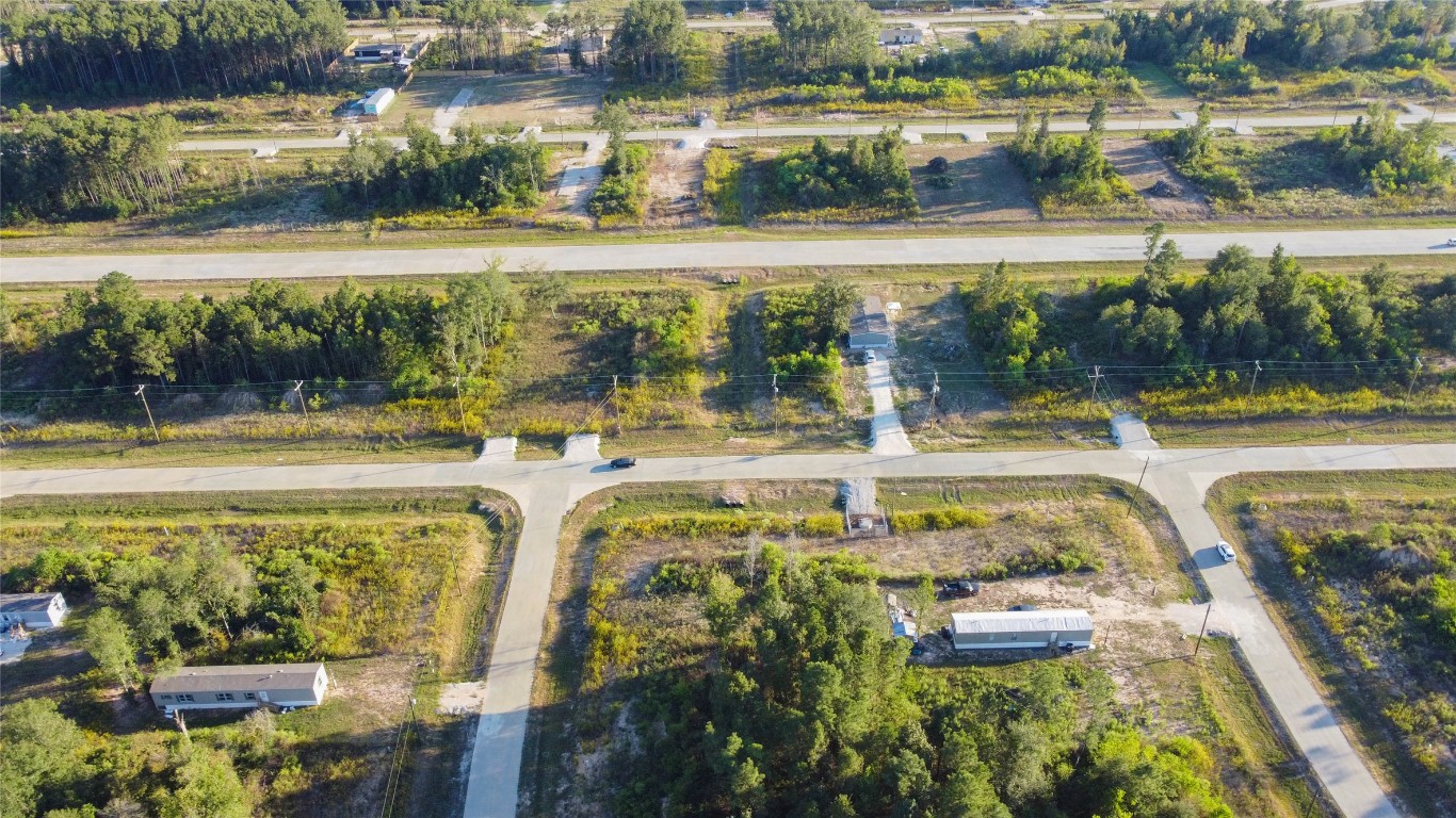 3009 Road 5913 Road, Unit 5 Cleveland, TX 77328 - Photo 6 of 6 a swimming pool with outdoor seating and a lake