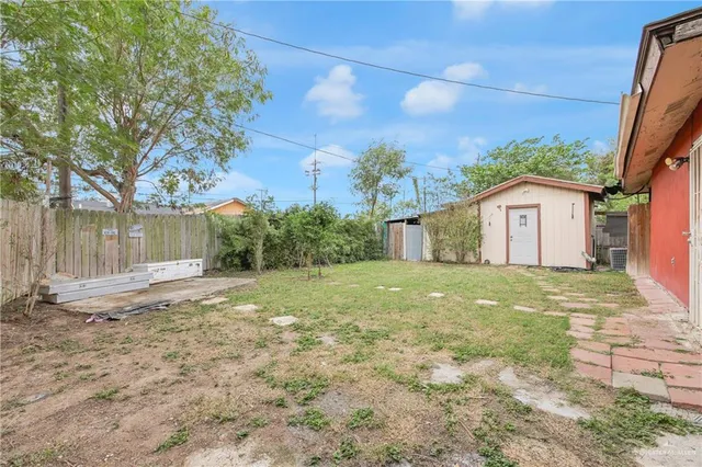 a view of a yard with a house and a large tree