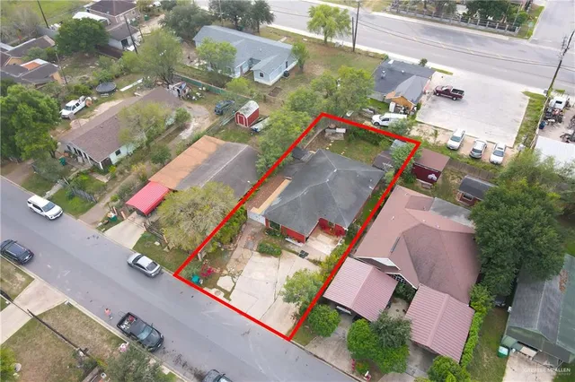 an aerial view of a house with a yard and pool