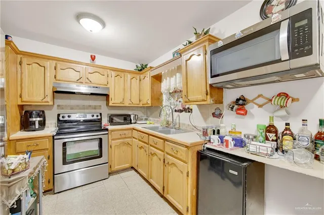 a kitchen with stainless steel appliances granite countertop a sink and cabinets