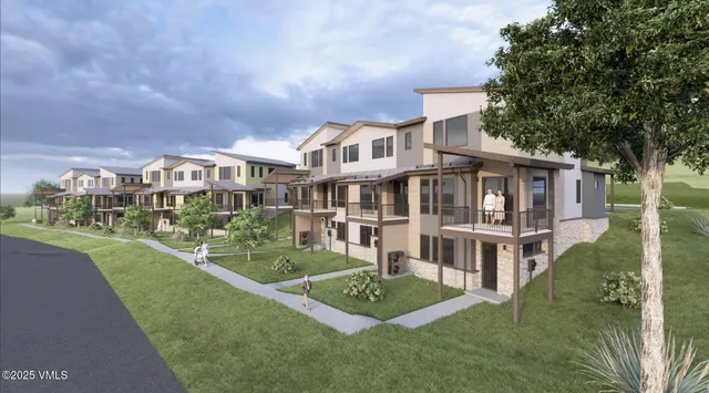 a front view of a house with a garden and plants