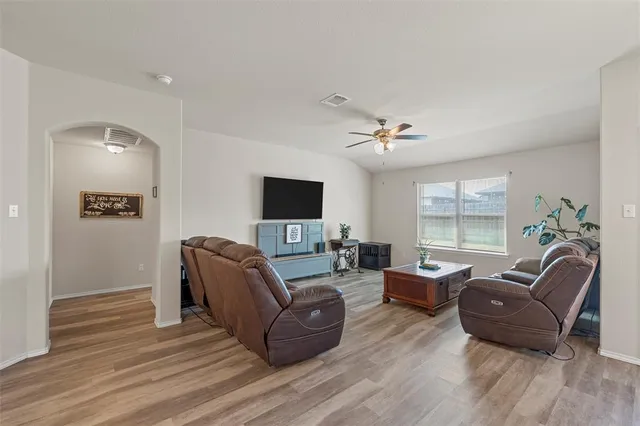 a view of a dining room with furniture a chandelier and wooden floor