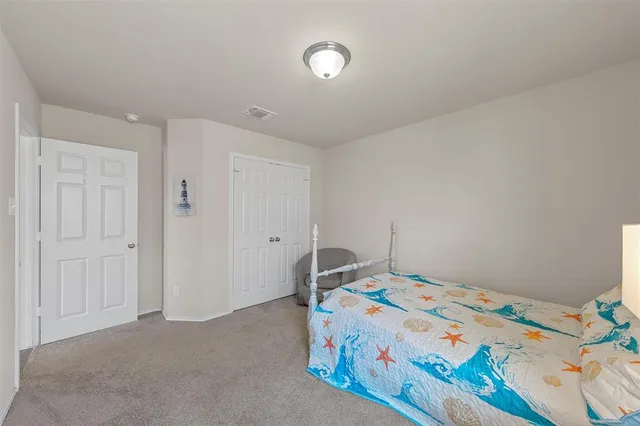 a bed sitting in a bedroom next to a window