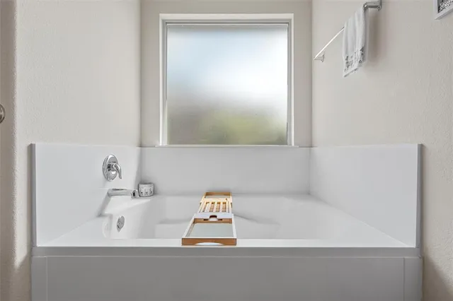 a bathroom with a bathtub and a sink